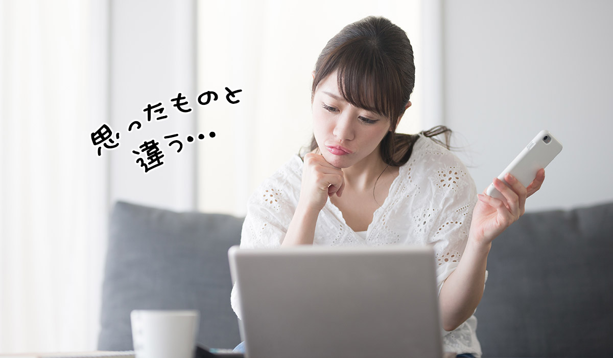 パソコンを見ながら悩ましい表情の女性